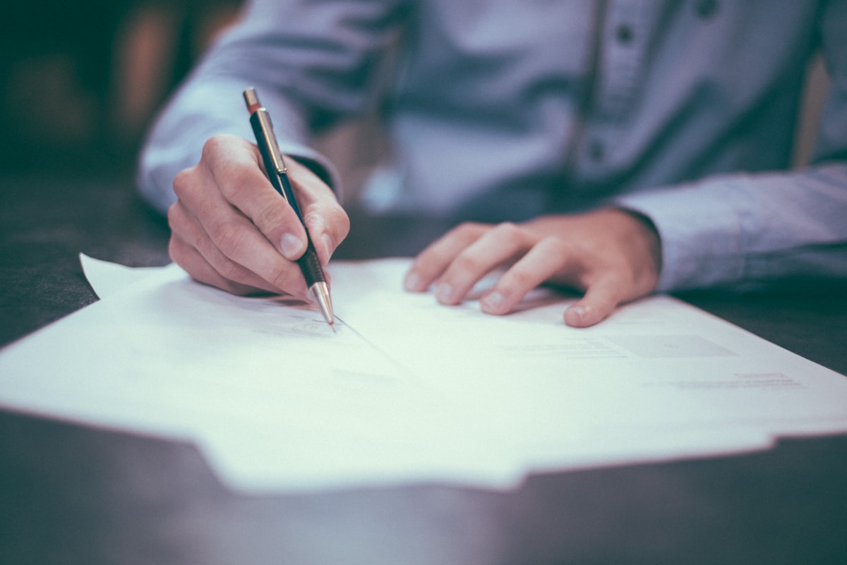 Signing legal documents at a desk